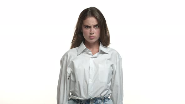 Closeup of Attractive Brunette Woman in White Collar Shirt Looking Confused Clip Her Eyes at