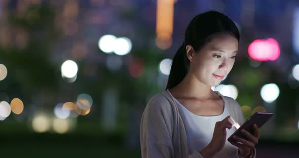 Woman Sending Sms on Smart Phone at Night