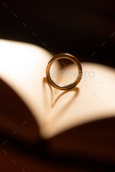 Wedding ring on the pages of a book in a heart shape