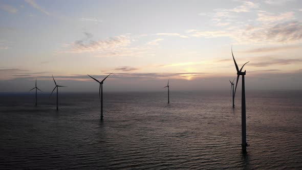 Offshore Windmill Park with Clouds and a Blue Sky Windmill Park in the Ocean Drone Aerial View with