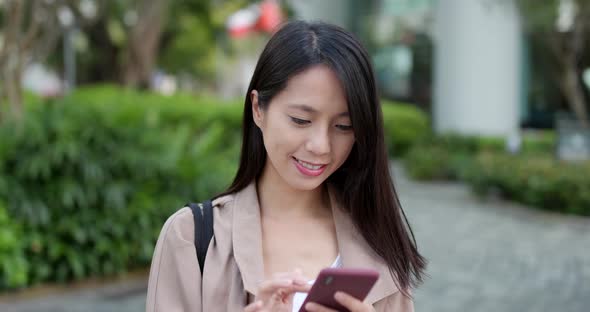 Young Woman use of mobile phone for online