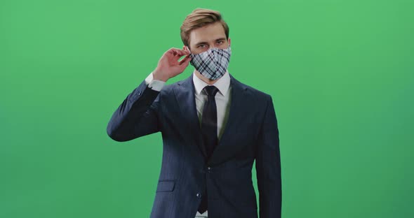 Young Businessman in a Suit Takes Off His Protective Mask and Leaves the Frame, Chroma Key