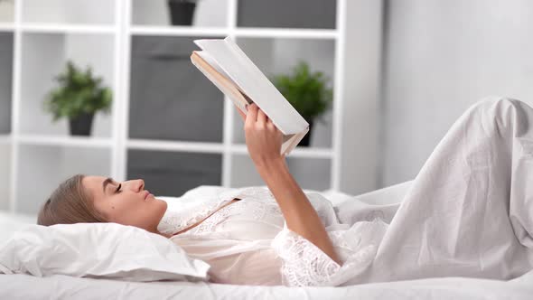 Calmness Relaxed Woman in Lingerie Reading Book Lying on Bed