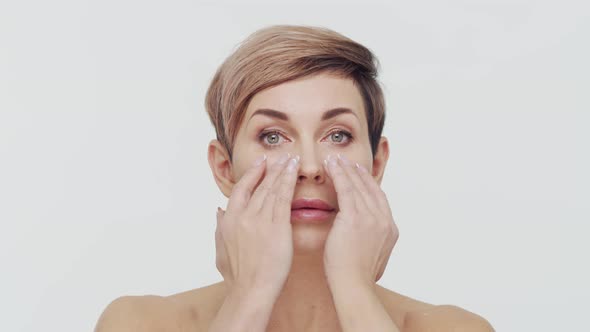 Close-up of middle aged mature woman over white background.