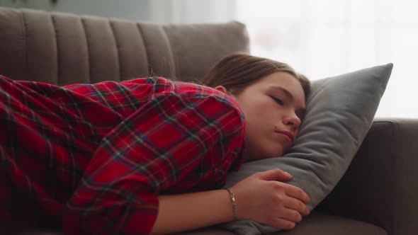 Pretty Tired Young Woman in Casual Garment Sleeps on Sofa