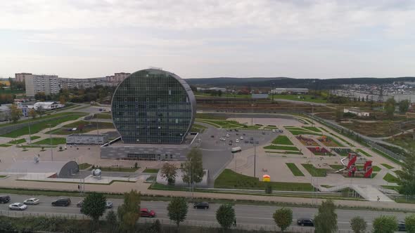 Aerial view of modern glass building in the city in the form of a washer 17