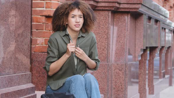 Distressed Confused Young AfroAmerican Woman Siting on Stairs Outdoors Feel Chills Alone