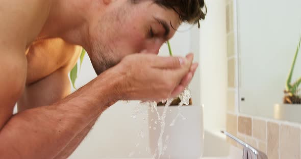 Young man washing his face with tap water 4K 4k