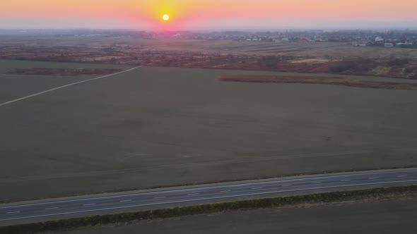 Aerial View of Intercity Road with Fast Driving Cars at Sunset