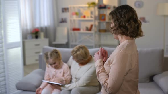Young Mother Admiring Daughter Playing Tablet With Grandmother, Togetherness