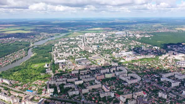 Cityscape under blue clouds. Beautiful view on the city surrounded by nature. 