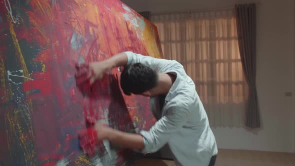 Male Artist Draws With His Hands On The Large Canvas