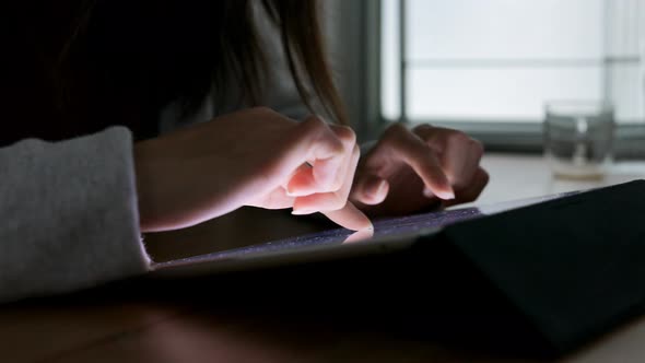 Woman using tablet computer at home