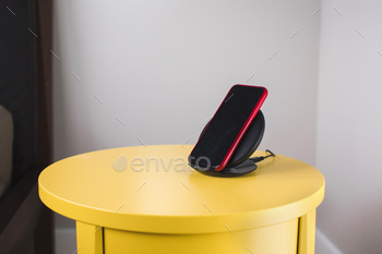 Smartphone on a wireless fast charger station