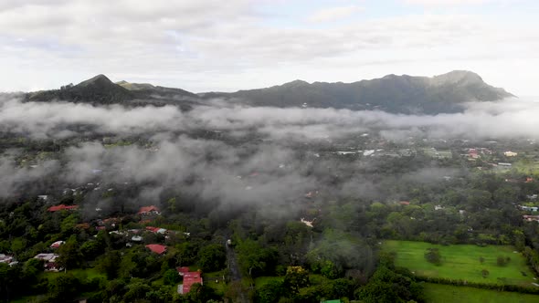 Low clouds cover town of Valle de Anton in central Panama located in extinct volcano crater, Aerial