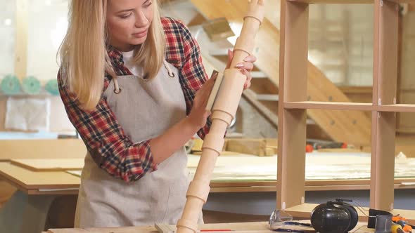 Carpenter Woman Grinding Piece of Wood