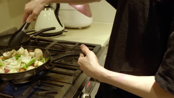 Chef In The Kitchen Cooking Delicious Korean Beef Bulgogi In Pan With Fresh Vegetables And Mushrooms