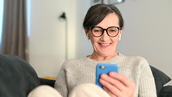 Senior Woman Using Smartphone at Home for Video Call