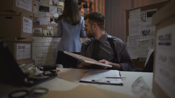 Cop Analyzing Witness Statement Files, Paper Working, Preparing Interrogation