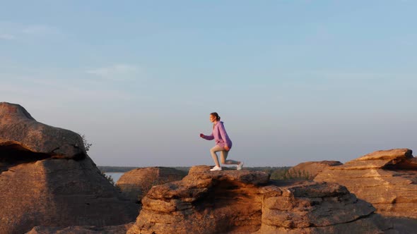 A Girl Does Fitness on a Hill at Sunset