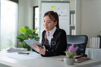 Businesswoman in office using tablet computer, audit documents and financial analysis, business