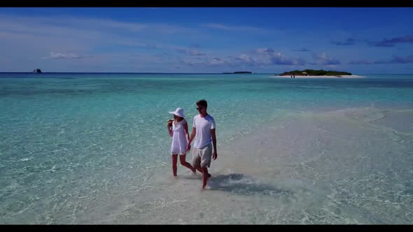 Man and woman tan on paradise bay beach voyage by turquoise lagoon with clean sand background of the