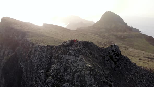 Drone Orbit Around Man Rising Hands at Epic Madeira Island Coastline