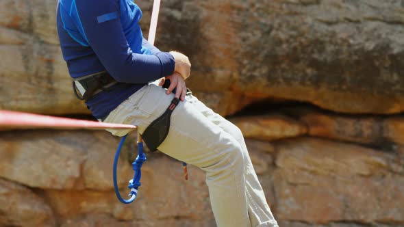 Mountaineer relaxing on the rope 4k