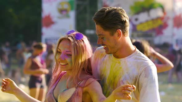 Couple Tenderly Hugging and Dancing at Holi Color Festival, Slow Motion