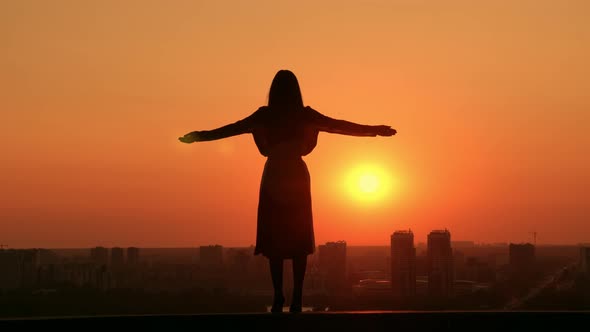 Successful Woman Raising Hands Outdoors Cityscape at Sunrise