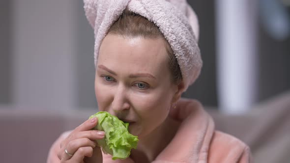 Tired Dissatisfied Young Woman in Hair Towel Eating Green Salad Leaf Sighing