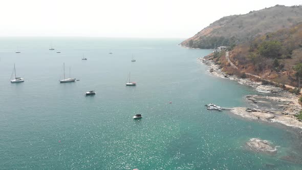 Yachts and motorboats at sea on sunny day. Tropical Island of Phuket