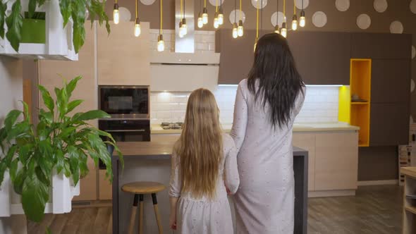 Live Camera Follows Confident Woman and Girl in Similar Dresses Walking in Luxurious Household