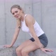Cheerful Sportswoman Sitting After Workout on Street - VideoHive Item for Sale