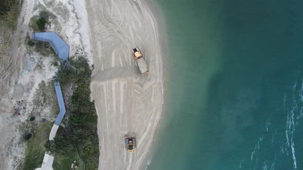 Unique view of large machinery working on a environmentally sensitive coastal rejuvenation project.