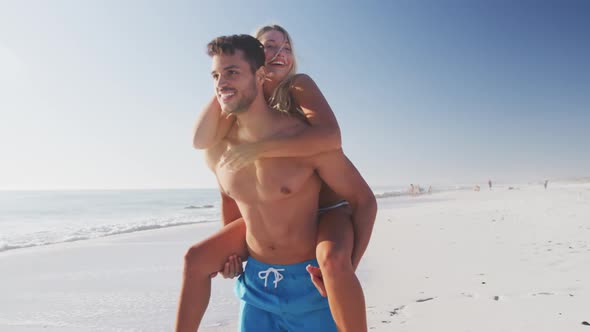 Caucasian couple enjoying time at the beach