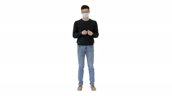 Coronavirus Man Wearing Protective Mask Cleaning His Hands with Sanitizer on White Background.