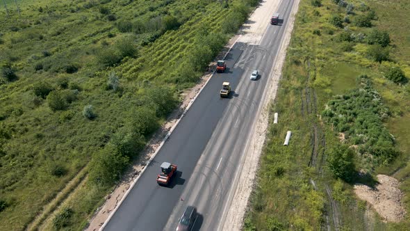 Aerial Top View of Roadworks with Road Workers Lay Asphalt