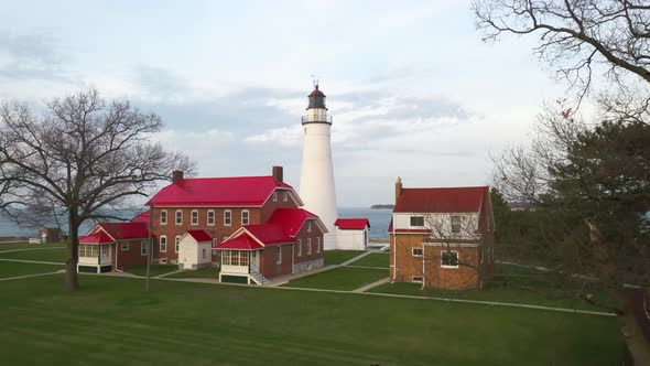 Fort Gratiot Lighthouse in Port Huron, Michigan with drone videoing forward from low ground.