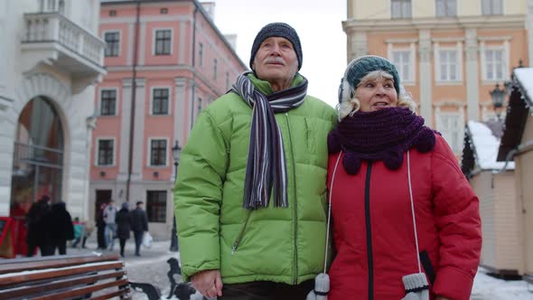 Senior Old Couple Tourists Man Woman Walking Talking Gesturing in Winter Snowy City Lviv Ukraine