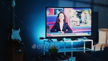 TV in apartment showing news broadcast