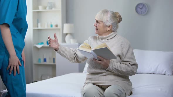 Elderly Woman Holding Book Asking Nurse for Eyeglasses, Vision Problems, Health