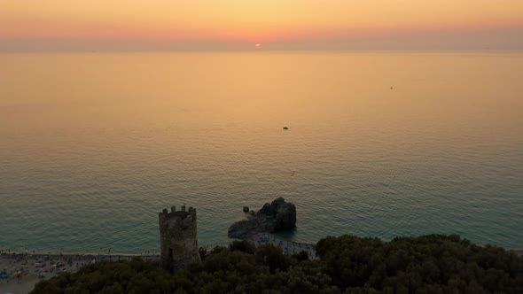 Silhouette of Tower and Castle on the Ocean at sunset