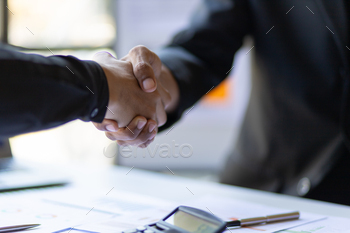 Business people shaking hands in business partnership meeting.