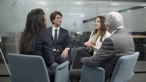 Cheerful Business Team Communicating in Office