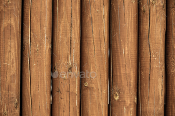 The texture of the logs. Wall of a rural house made of wooden logs with knots. Wooden background