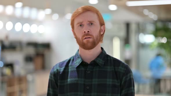 Portrait of Upset Beard Redhead Man Feeing Sad at Camera
