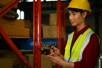 Male factory worker holding clipboard checking product material in factory