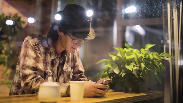 Portrait Of Stylish Man With Mobile Phone At Cafe