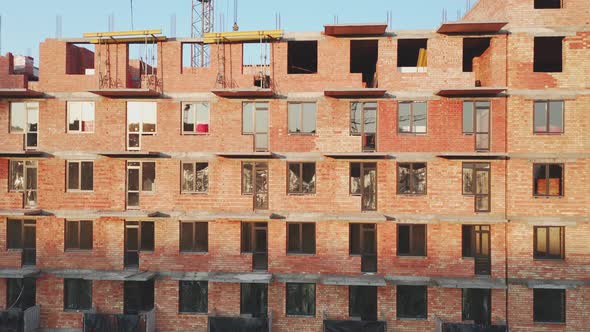 Aerial View of the Facade of a Residential Building at a Construction Site at Sunset